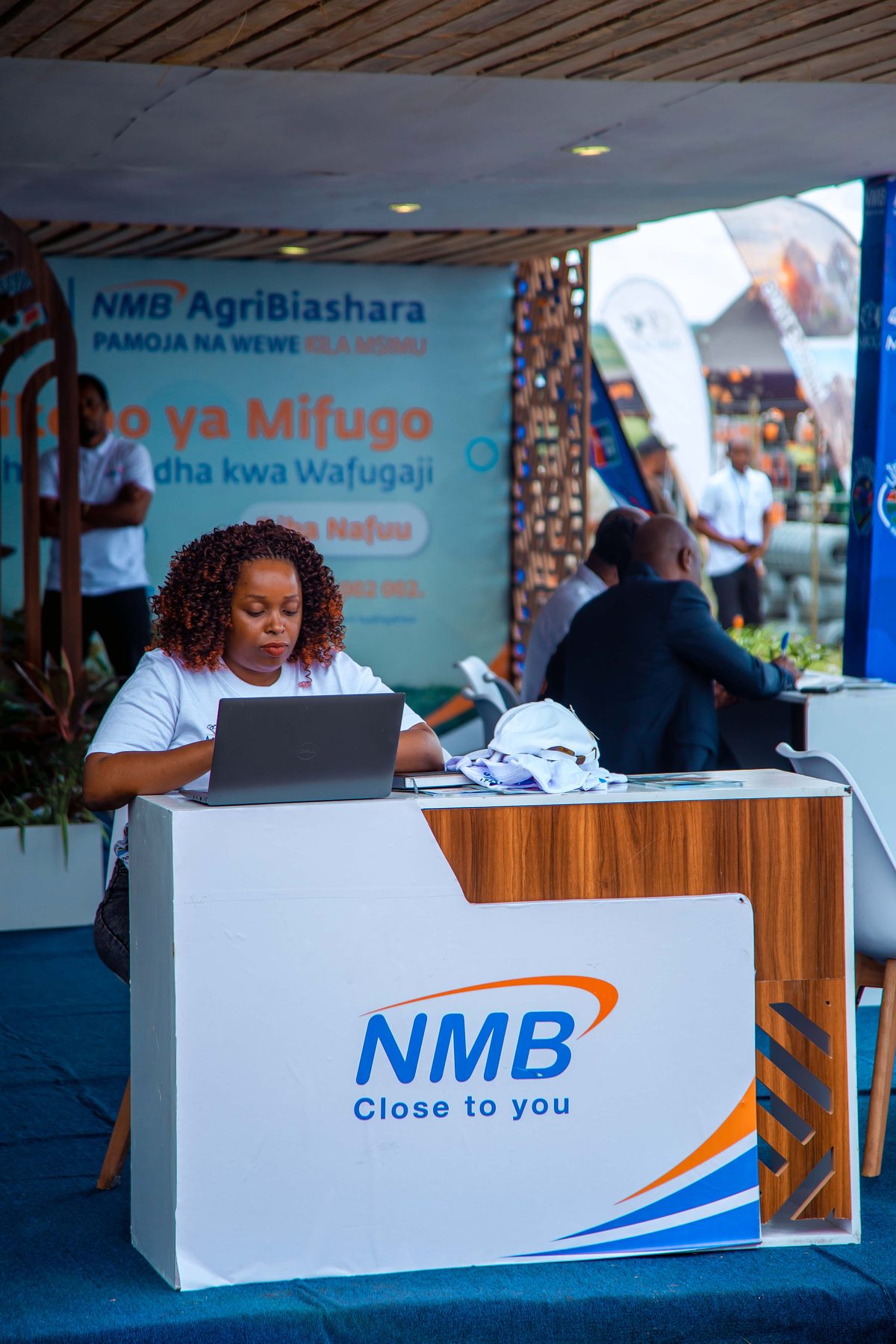 NMB staff member at the registration desk during the Ubena Zomozi exhibition