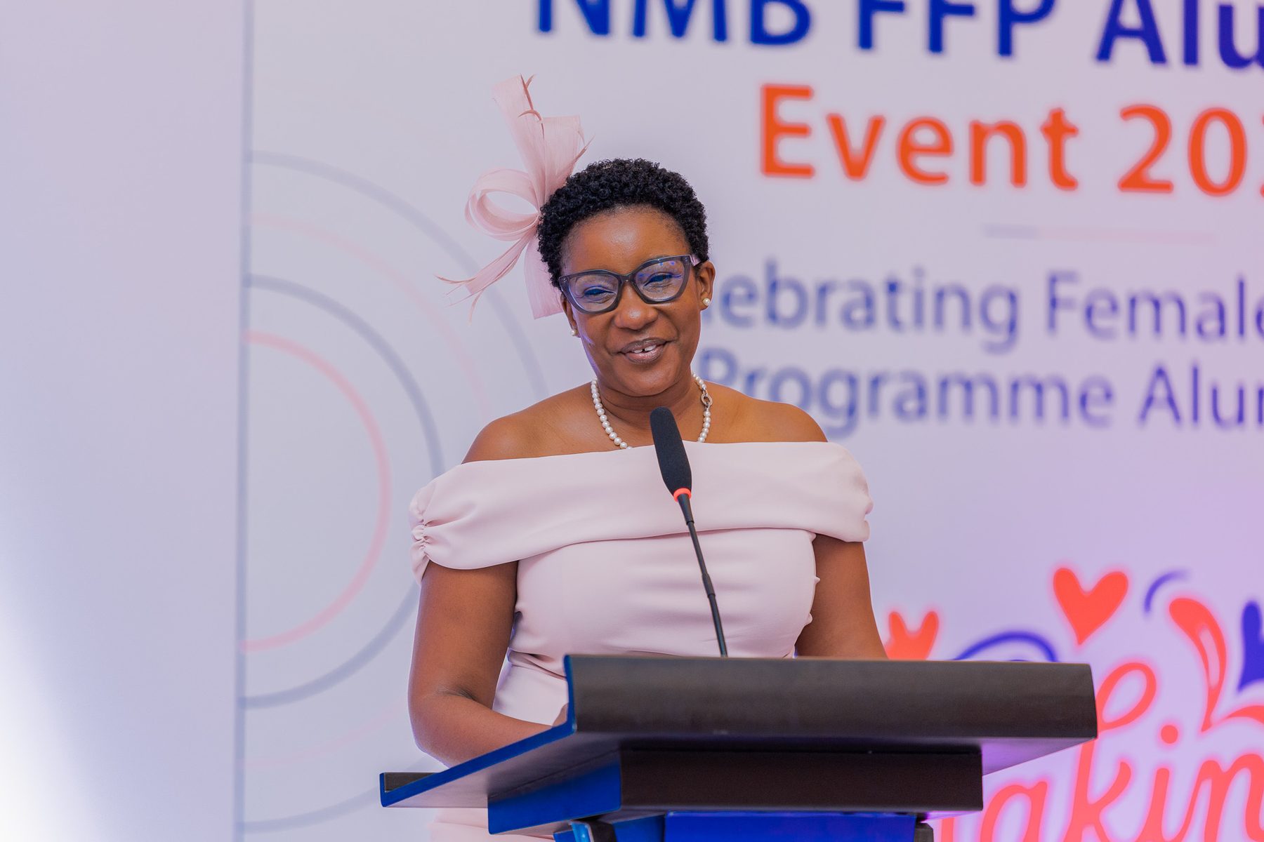 Speaker addressing guests at the podium, NMB FFP Alumnae Event 2026
