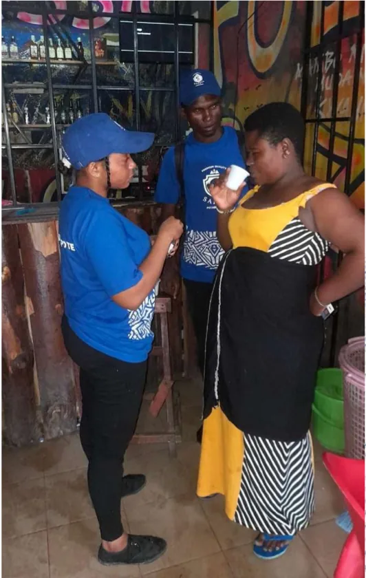 Safaya brand ambassadors sampling the product with a consumer inside a local bar