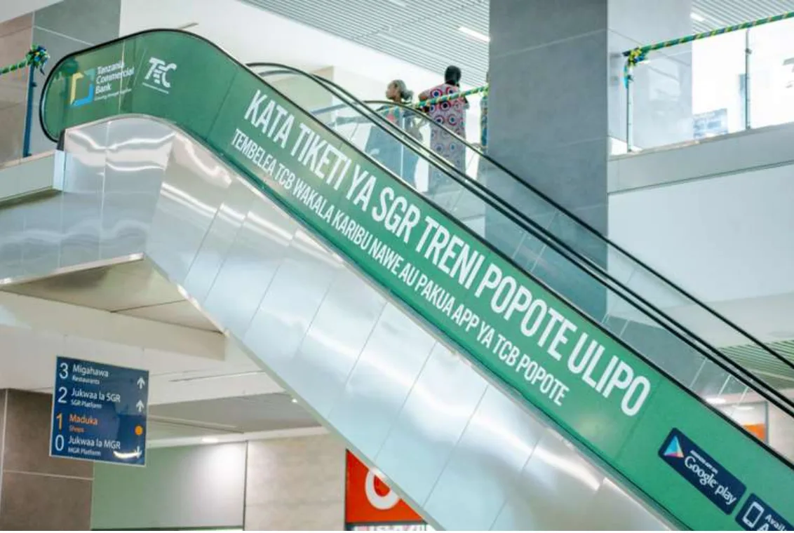 TCB Bank branded escalator panel inside an SGR station