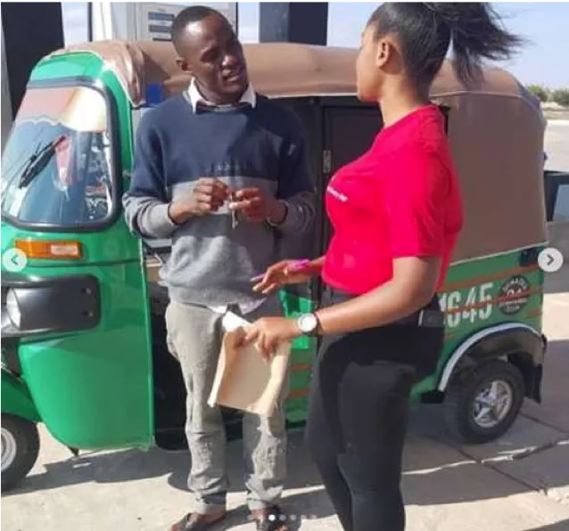 Oryx brand ambassador handing over prize vehicle keys to a customer